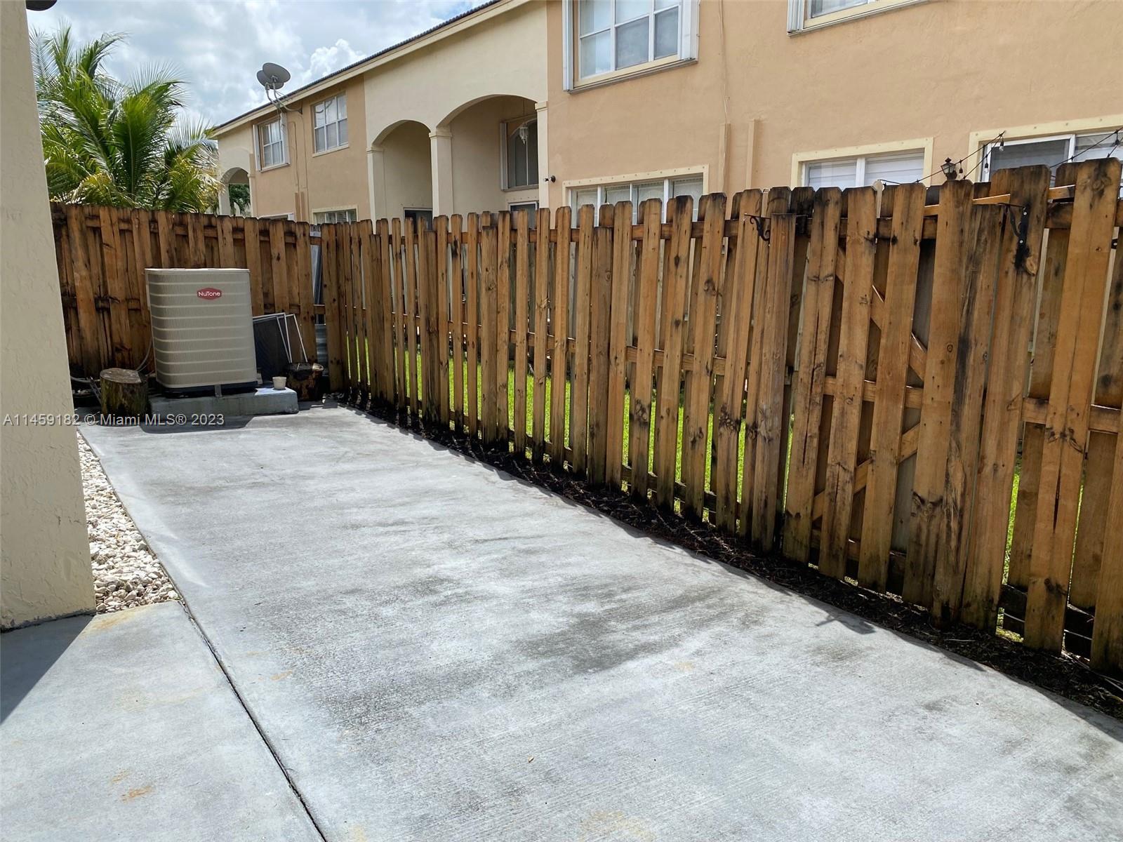 5586 Northwest 112th Path Doral, FL 33178 - Photo 27 of 30 a view of a house with a wooden fence