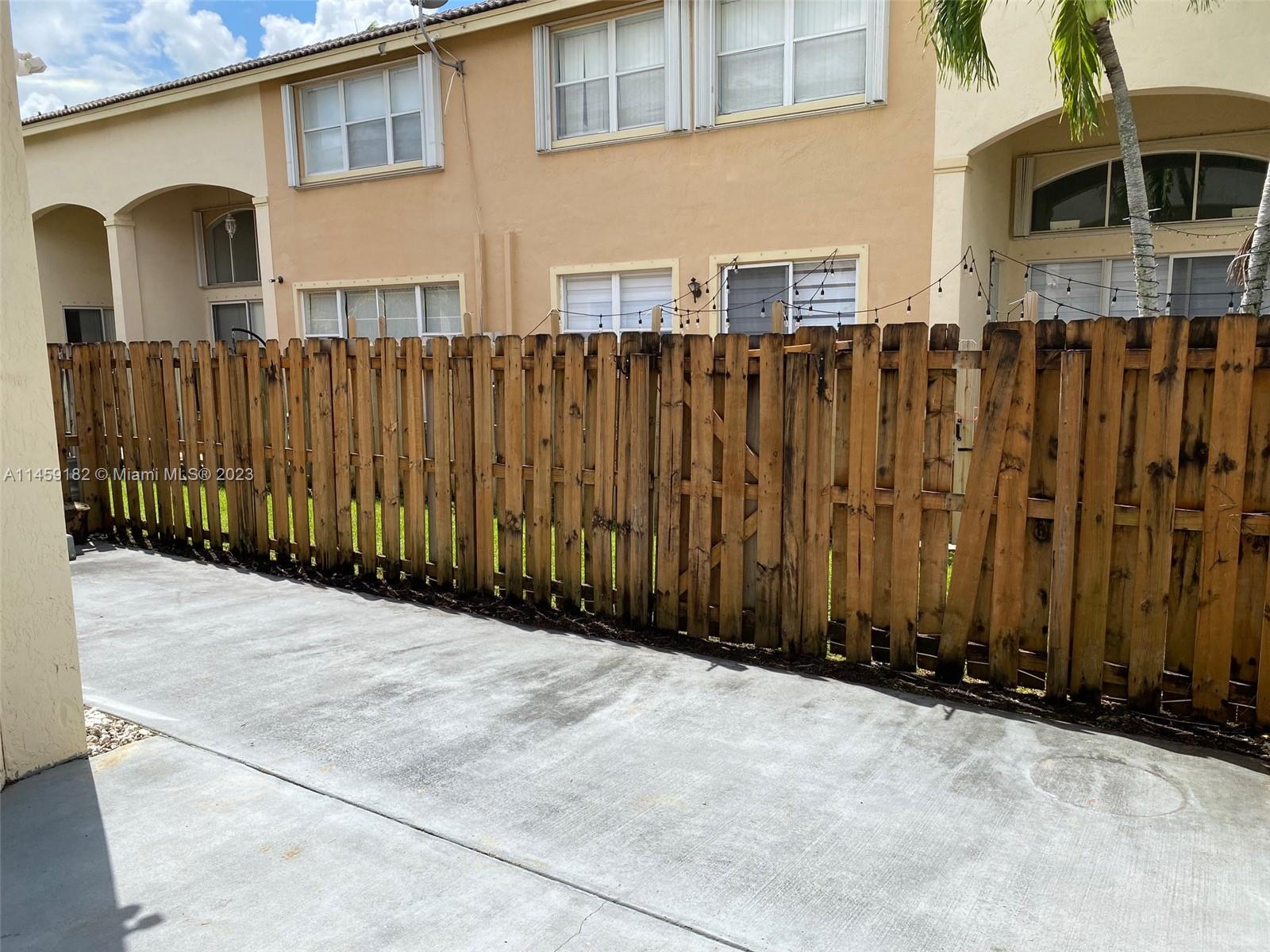 5586 Northwest 112th Path Doral, FL 33178 - Photo 28 of 30 a view of a house with a wooden fence
