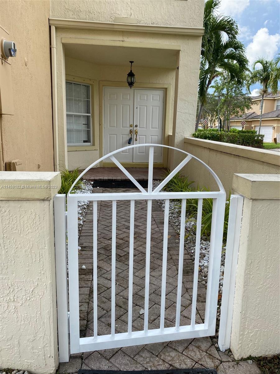 5586 Northwest 112th Path Doral, FL 33178 - Photo 3 of 30 a front view of a house with a porch