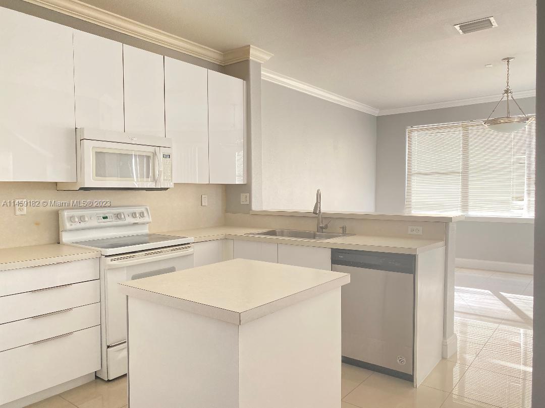 5586 Northwest 112th Path Doral, FL 33178 - Photo 8 of 30 a kitchen with a sink stove and cabinets