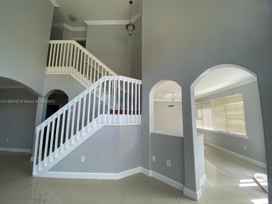 5586 Northwest 112th Path Doral, FL 33178 - Photo 10 of 30 a view of a hallway with a door and wooden floor