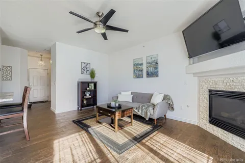 a living room with furniture a fireplace and a flat screen tv