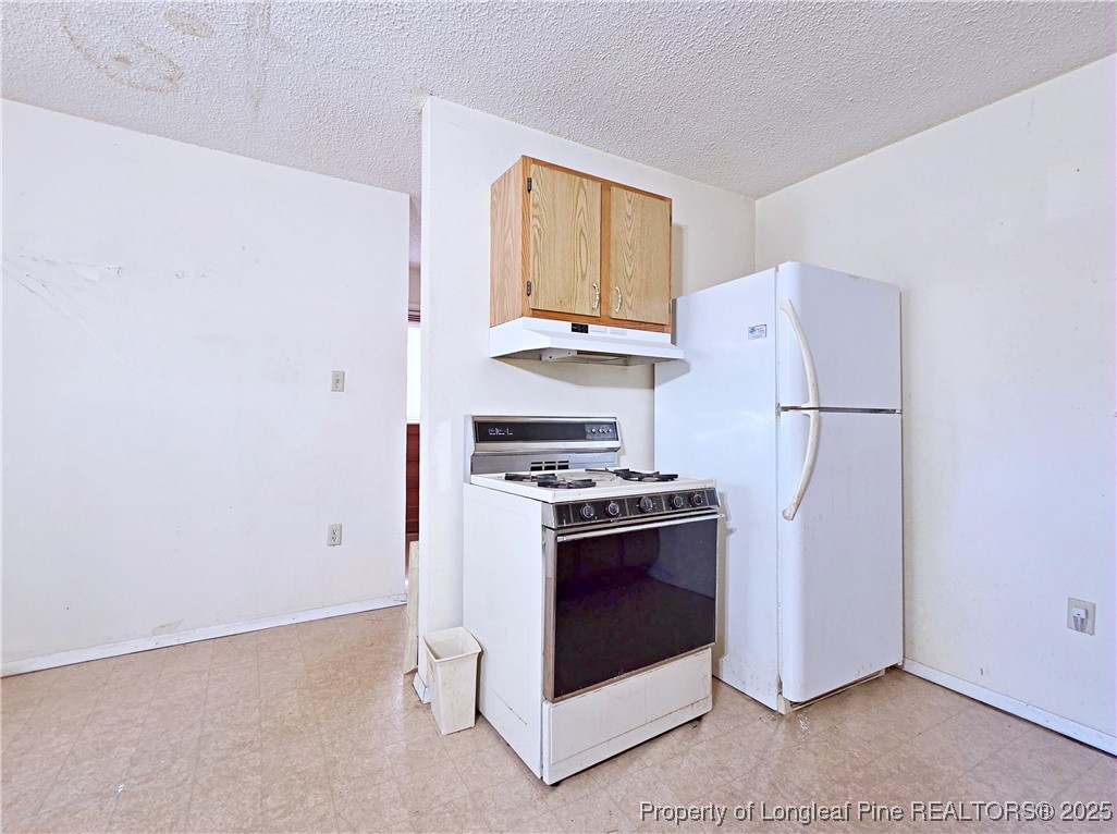 1621 Lobelia Road Vass, NC 28394 - Photo 11 of 50 a kitchen with stainless steel appliances granite countertop a refrigerator and a stove top oven