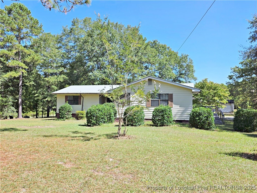 1621 Lobelia Road Vass, NC 28394 - Photo 32 of 50 a front view of a house with a yard