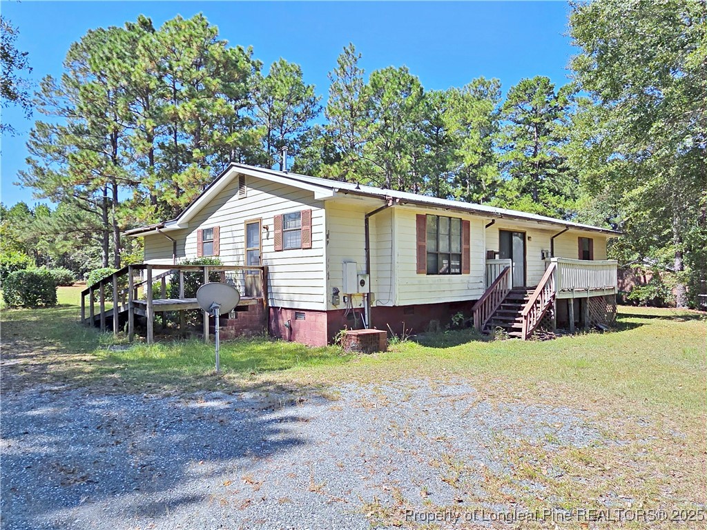 1621 Lobelia Road Vass, NC 28394 - Photo 37 of 50 a view of a house with a yard and sitting area