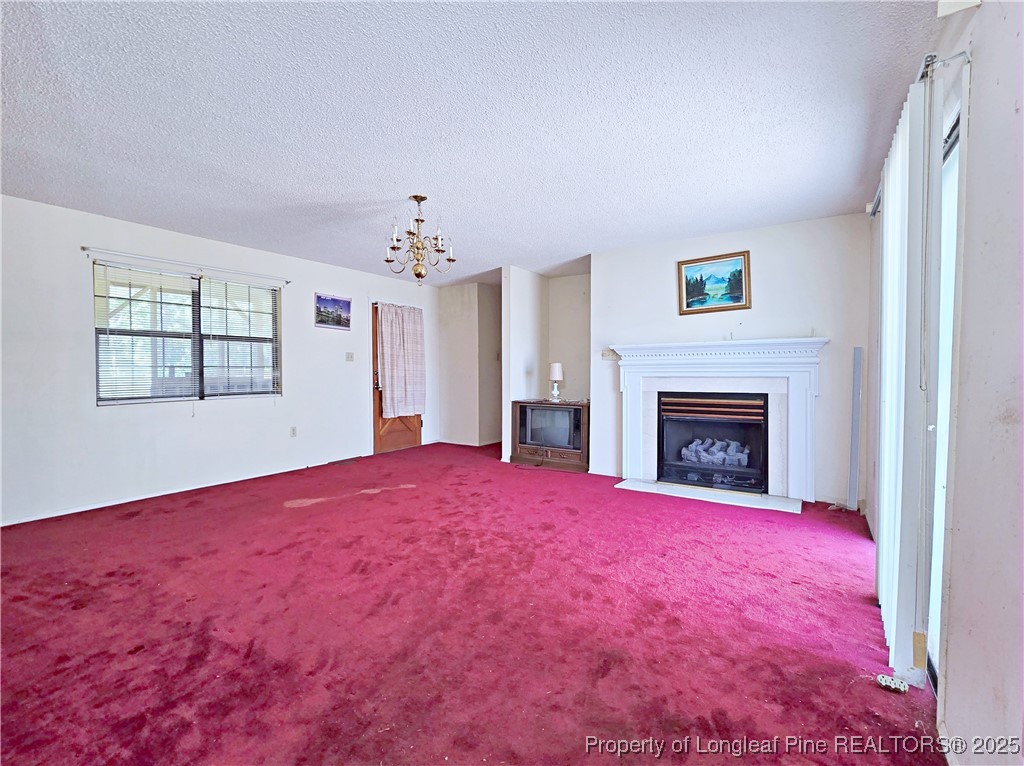 1621 Lobelia Road Vass, NC 28394 - Photo 4 of 50 a view of empty room with window and fireplace