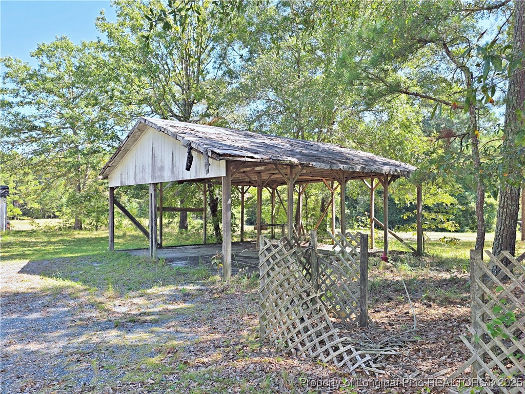 1621 Lobelia Road Vass, NC 28394 - Photo 41 of 50 a backyard of a house with table and chairs