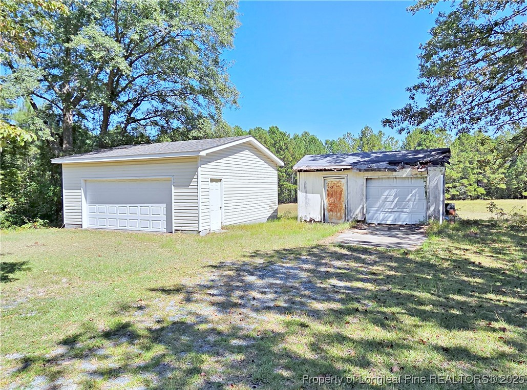 1621 Lobelia Road Vass, NC 28394 - Photo 43 of 50 a view of a house with a yard and a tree