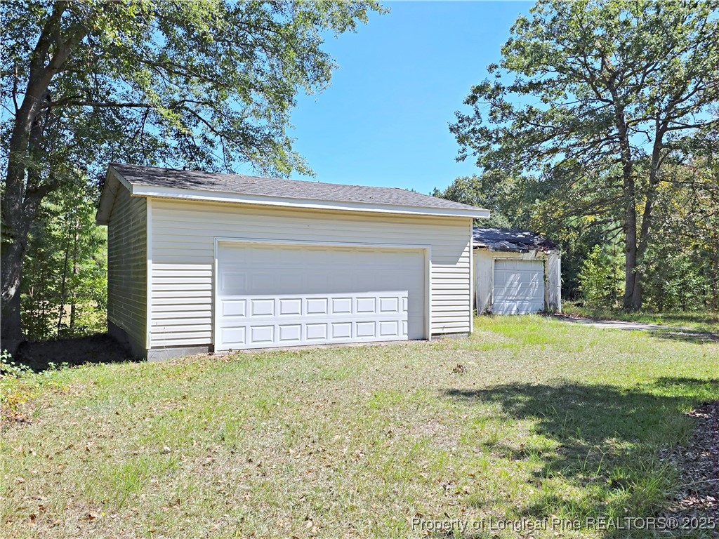 1621 Lobelia Road Vass, NC 28394 - Photo 44 of 50 a front view of a house with a yard and garage