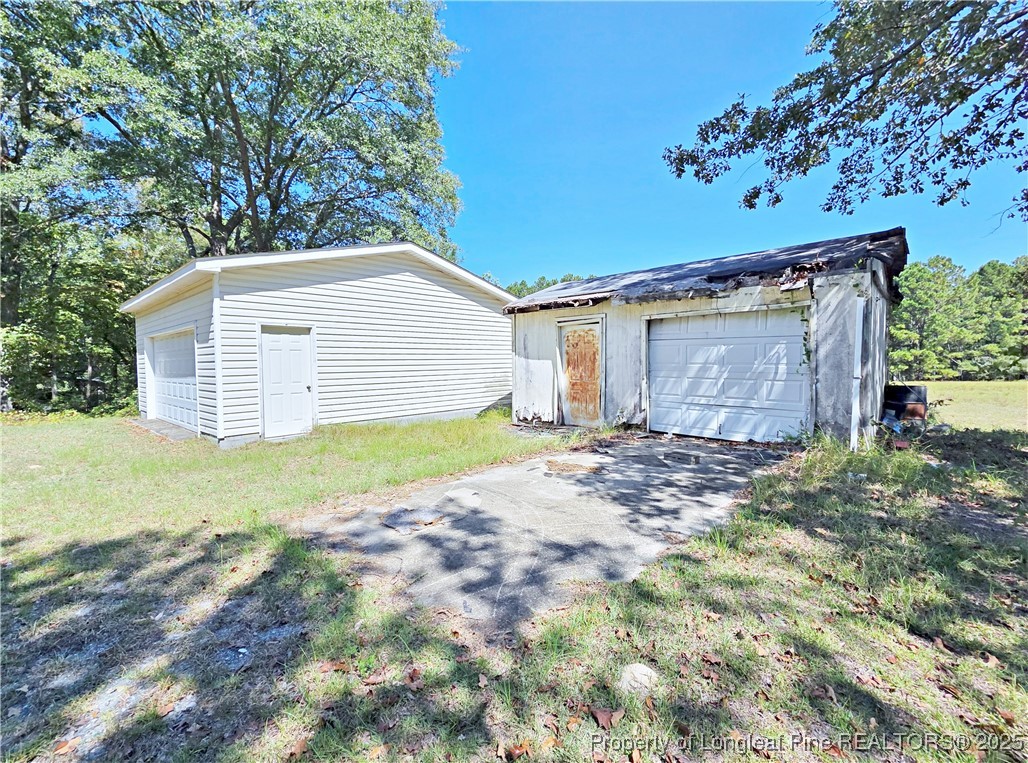 1621 Lobelia Road Vass, NC 28394 - Photo 47 of 50 a view of a house with a yard and garage