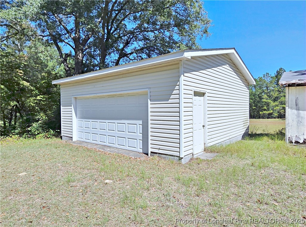 1621 Lobelia Road Vass, NC 28394 - Photo 48 of 50 a view of a house with a yard and garage