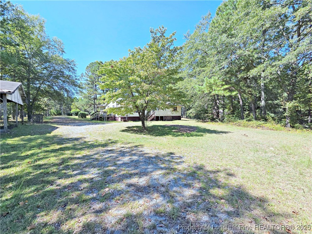 1621 Lobelia Road Vass, NC 28394 - Photo 50 of 50 a view of a field with trees in the background
