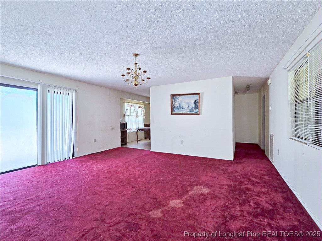 1621 Lobelia Road Vass, NC 28394 - Photo 6 of 50 a view of empty room with window and wooden floor