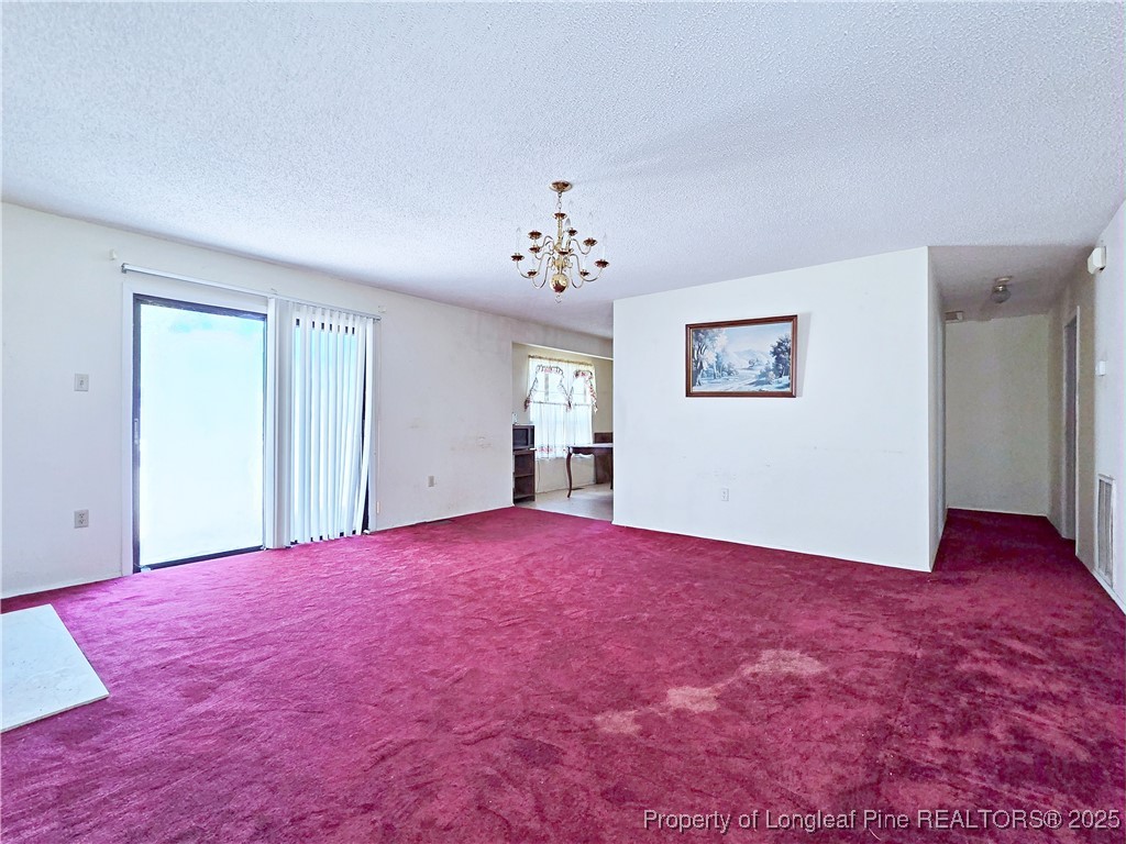 1621 Lobelia Road Vass, NC 28394 - Photo 7 of 50 a view of empty room with window and wooden floor