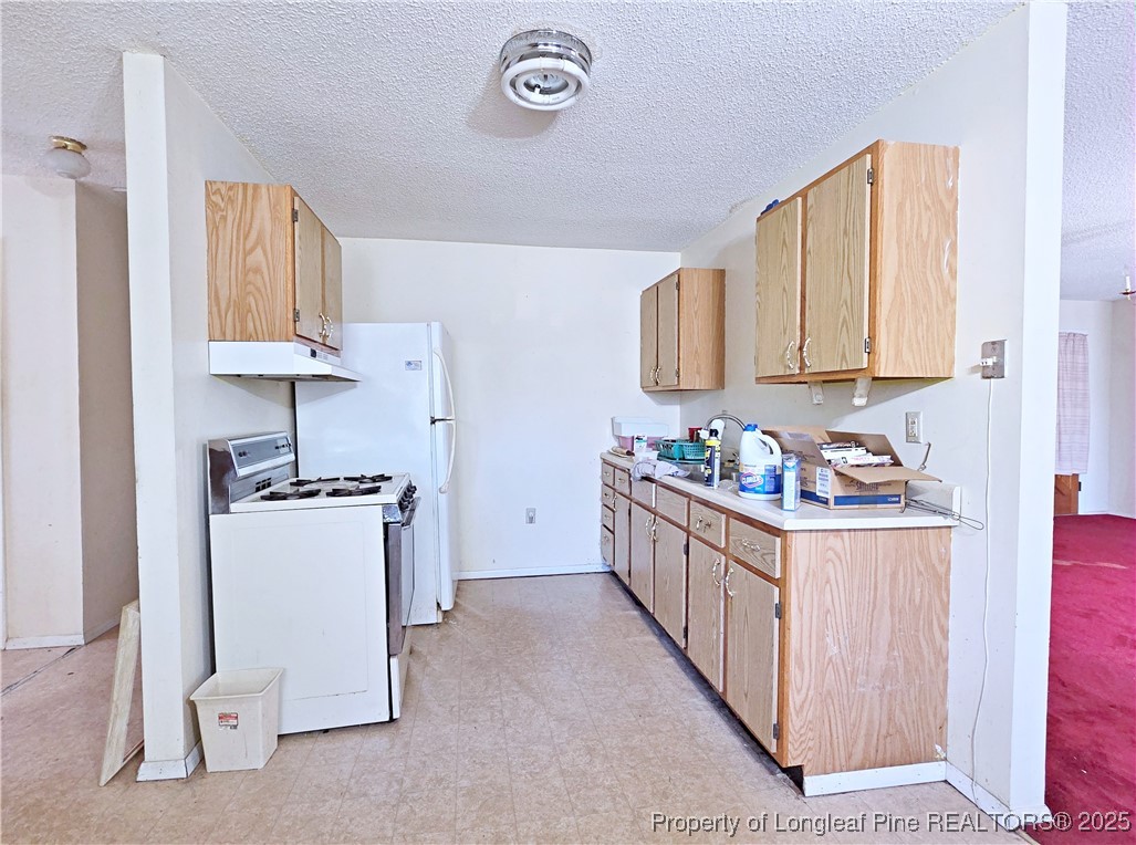 1621 Lobelia Road Vass, NC 28394 - Photo 9 of 50 a kitchen with sink cabinets and stove