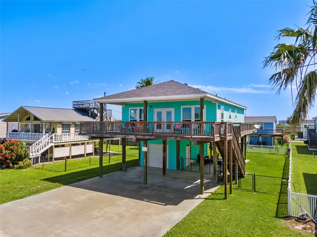 a view of a house with a yard and sitting area