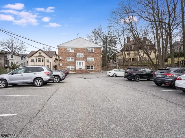 a view of a cars park in front of a building