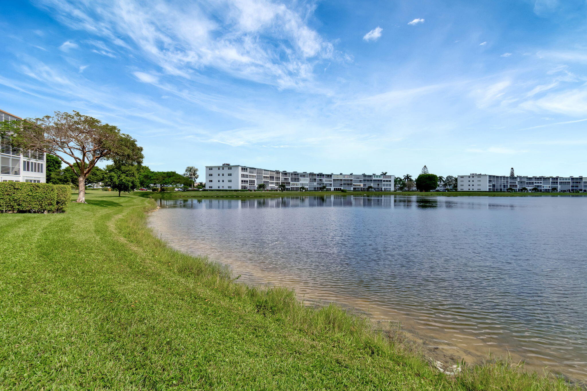 3031 Cornwall East Boca Raton, FL 33434 - Photo 34 of 84 a view of a lake with houses in the back