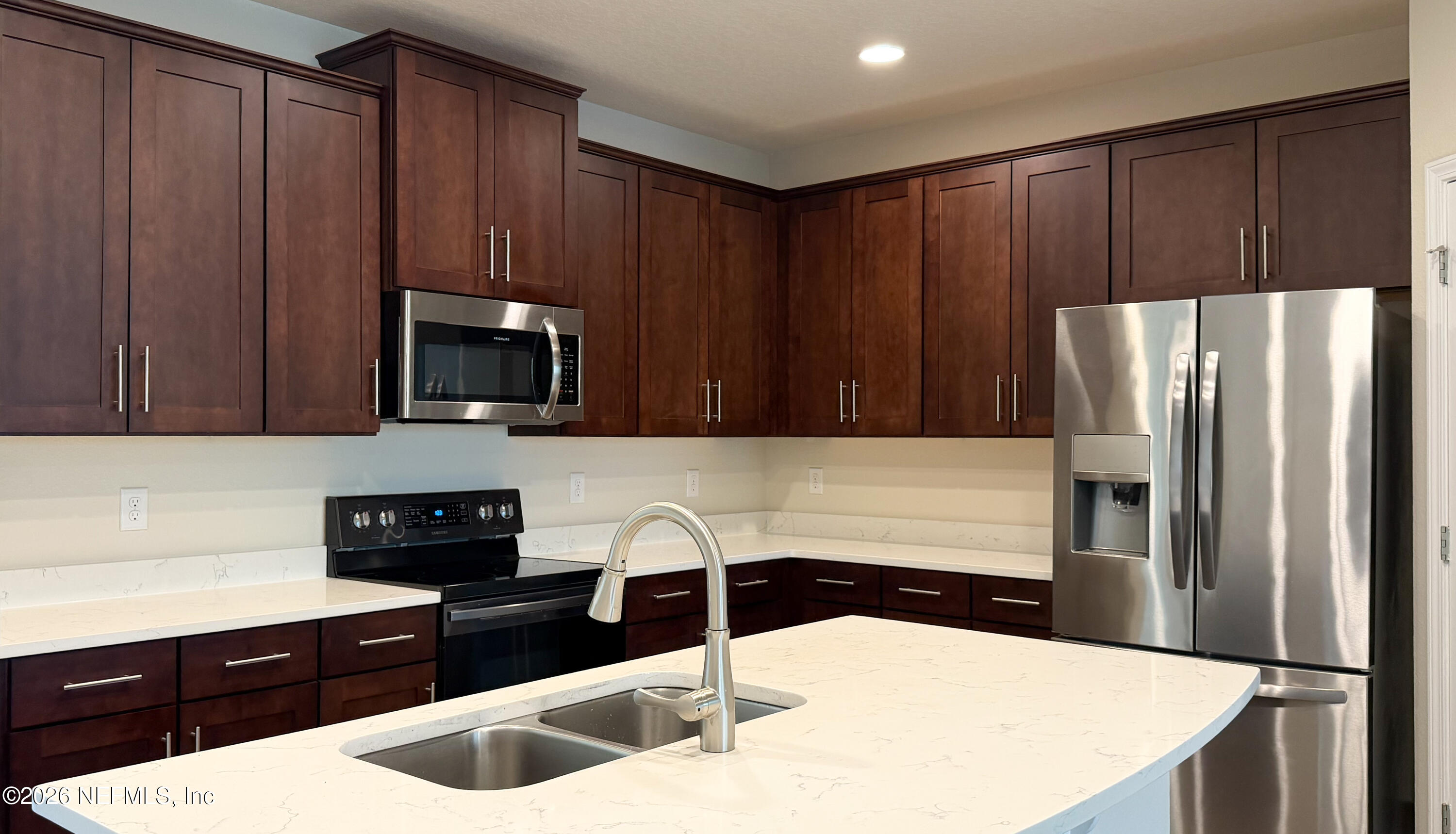 47 Castro Court St. Johns, FL 32259 - Photo 4 of 19 a kitchen with stainless steel appliances a refrigerator a sink a stove a microwave and wooden cabinets