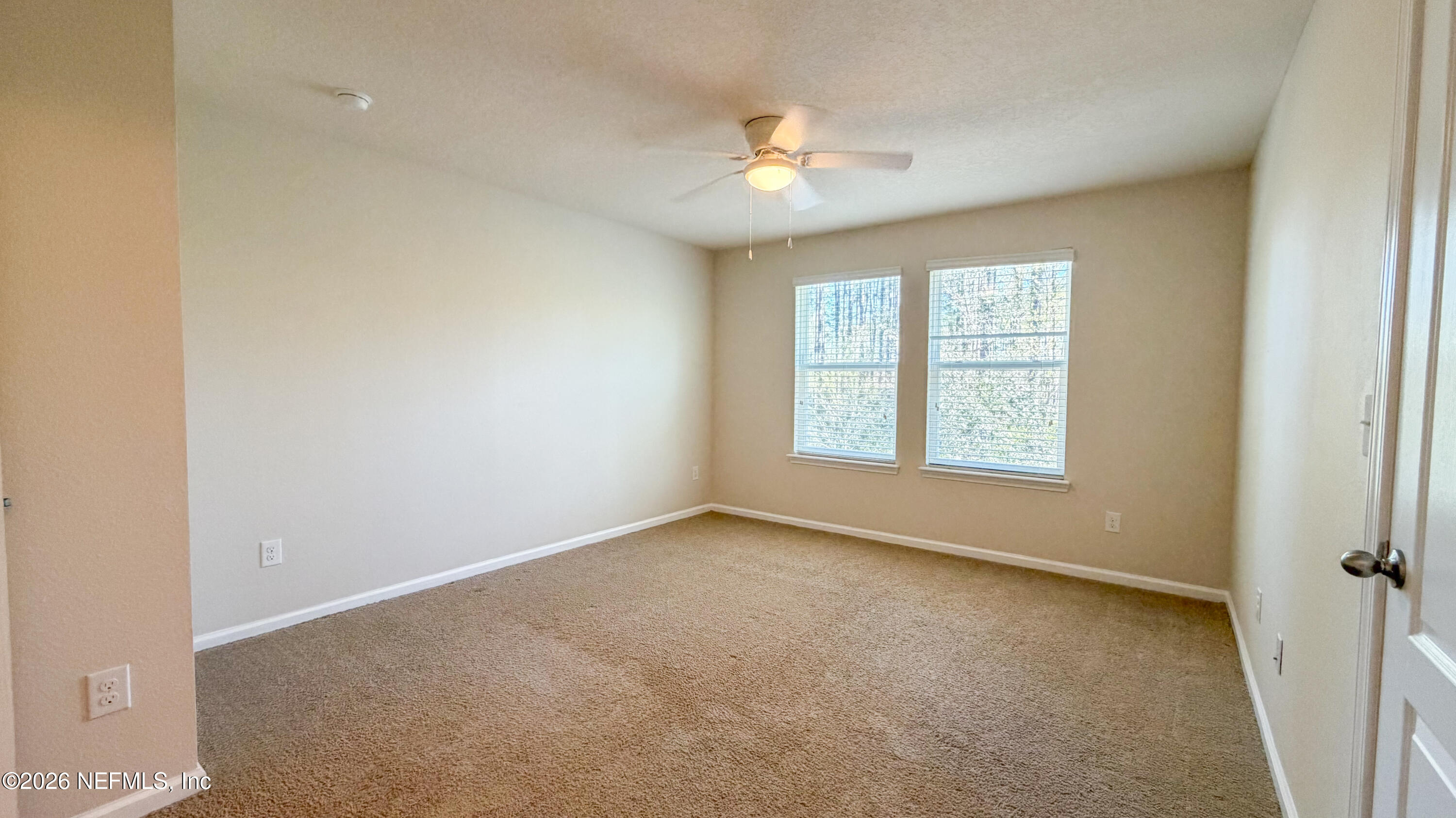 47 Castro Court St. Johns, FL 32259 - Photo 6 of 19 an empty room with a chandelier fan and windows