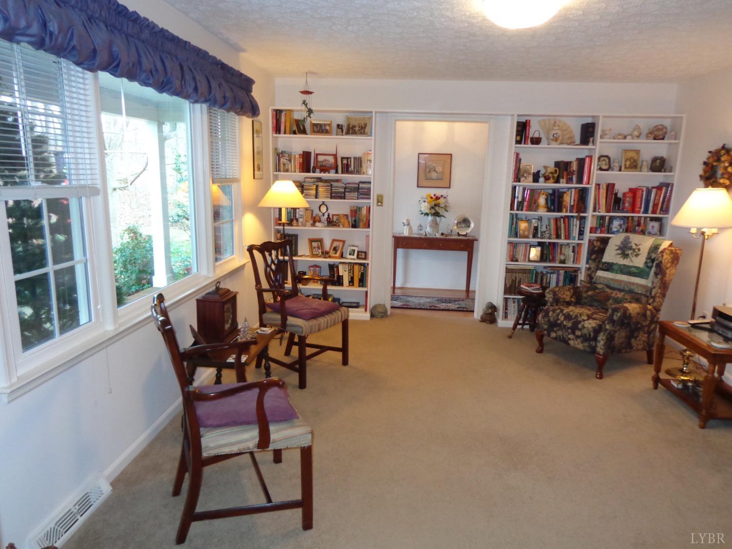 218 Otterview Road Forest, VA 24551 - Photo 17 of 63 Formal LR looking towards entry foyer, entire wall of built in bookshelves