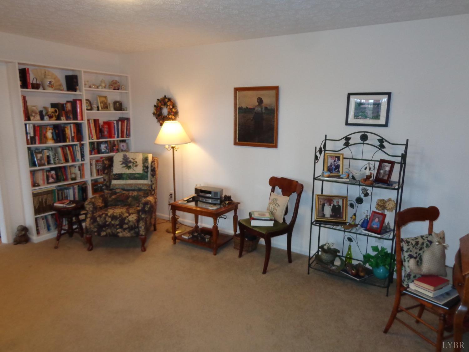 218 Otterview Road Forest, VA 24551 - Photo 19 of 63 a living room with furniture a bookshelf and a window