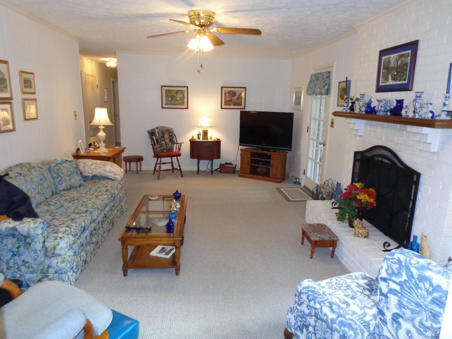 218 Otterview Road Forest, VA 24551 - Photo 24 of 63 a living room with furniture and a flat screen tv