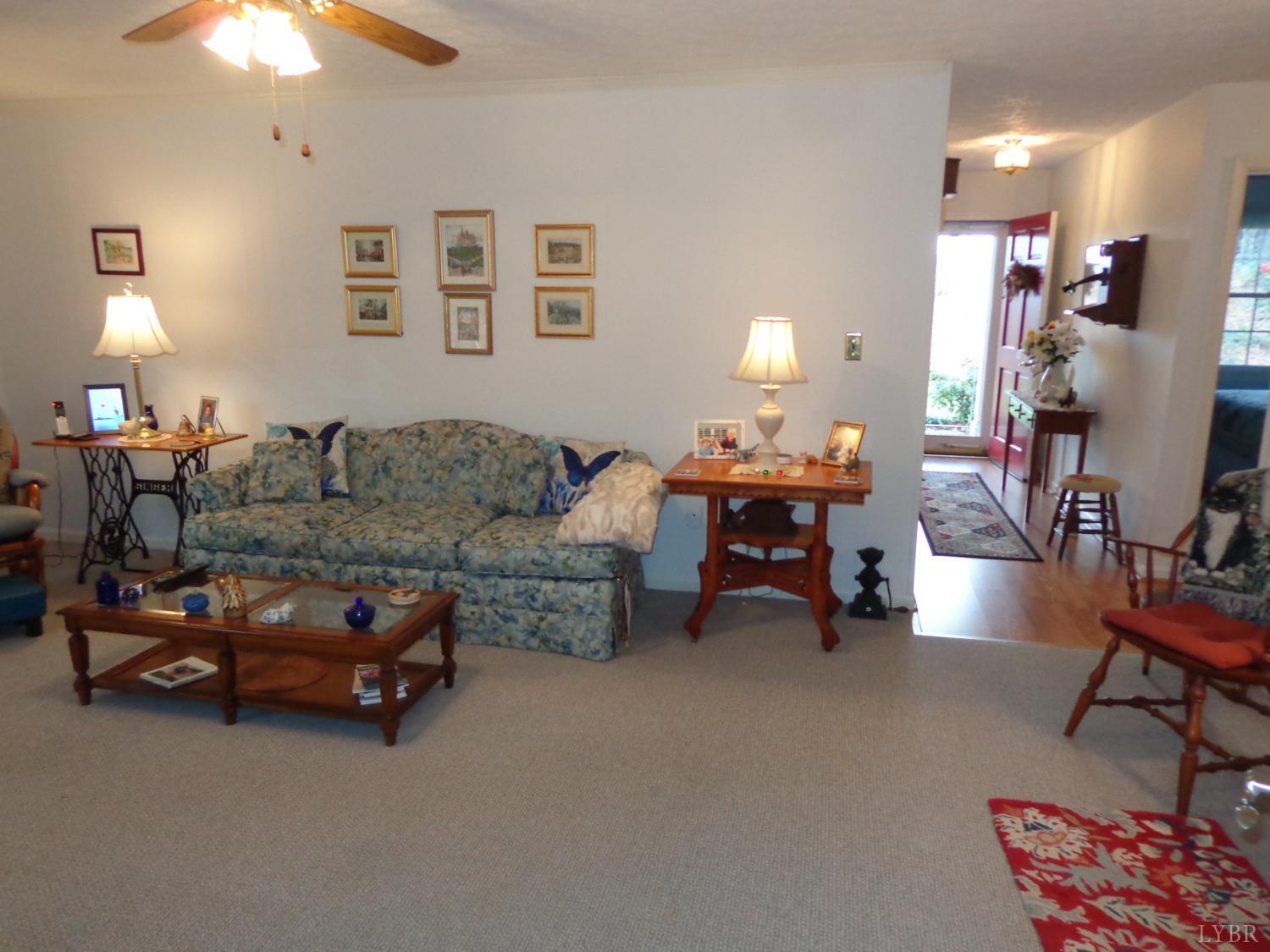 218 Otterview Road Forest, VA 24551 - Photo 25 of 63 a living room with furniture and a chandelier