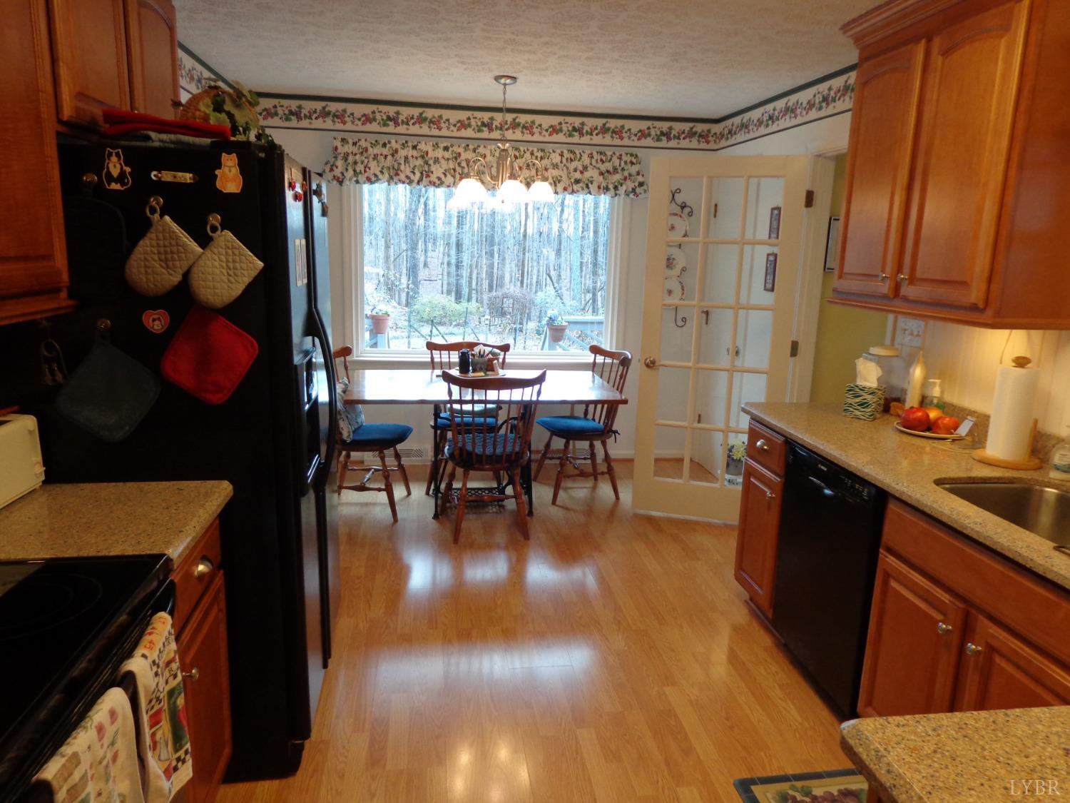 218 Otterview Road Forest, VA 24551 - Photo 26 of 63 a kitchen with a table chairs and a wooden floor