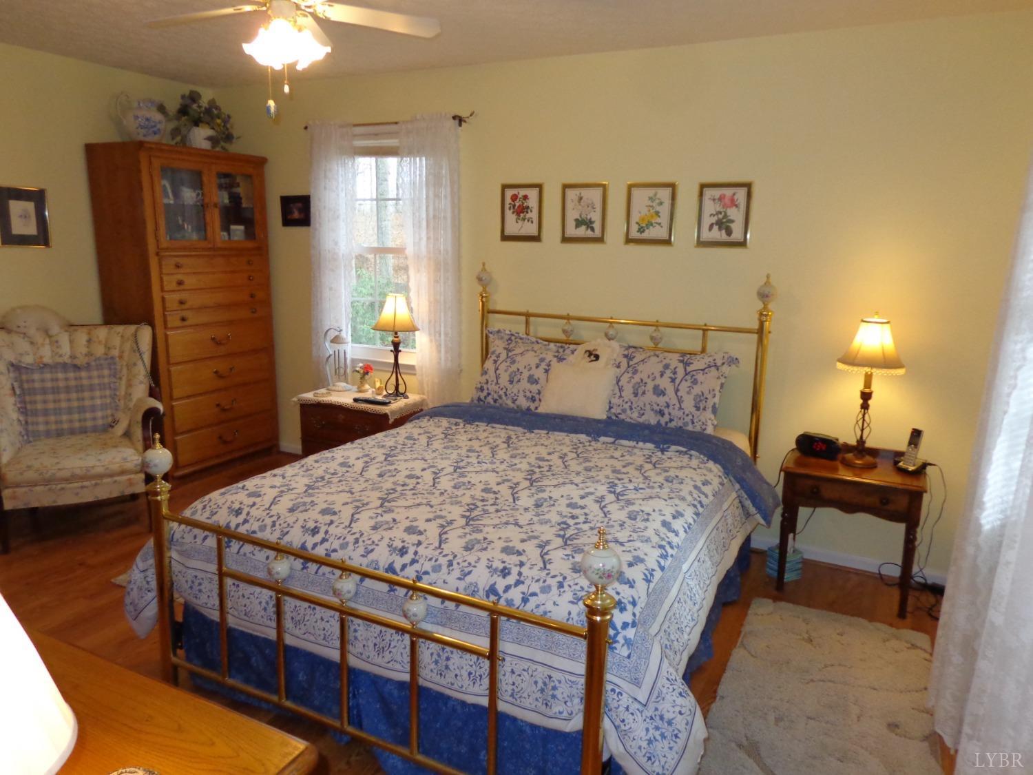 218 Otterview Road Forest, VA 24551 - Photo 49 of 63 a bedroom with a bed and dresser with mirror
