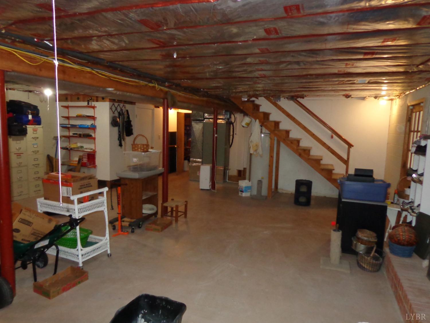 218 Otterview Road Forest, VA 24551 - Photo 57 of 63 Stairs to basement from 1st floor , gas log FP to right