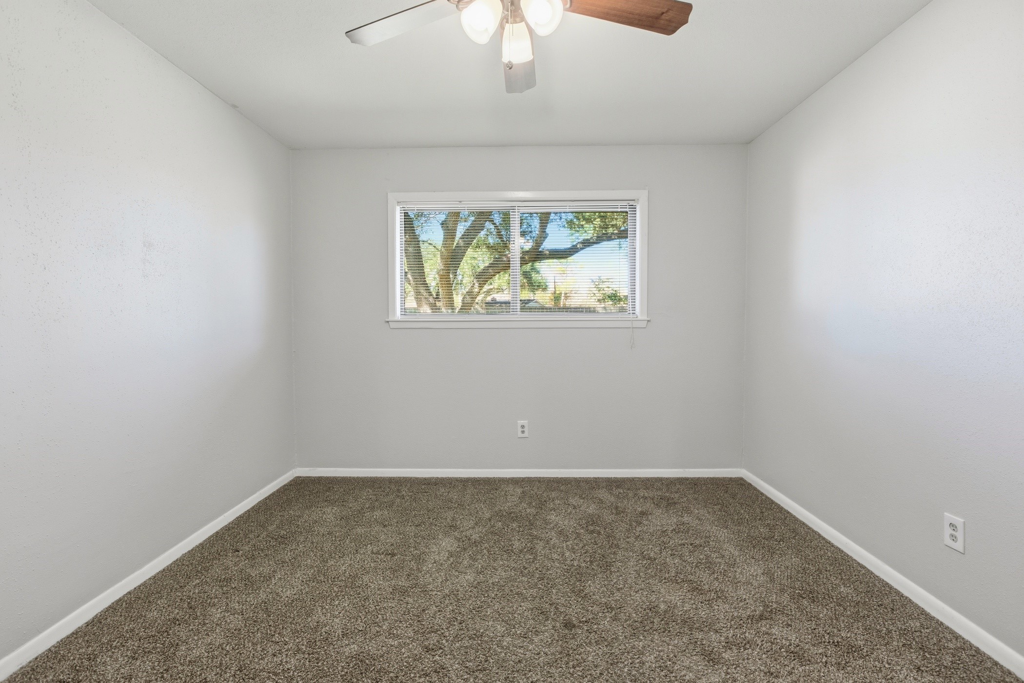 3721 Avenue R Rosenberg, TX 77471 - Photo 32 of 43 Light and bright secondary bedroom with window views of the backyard and recent carpet.