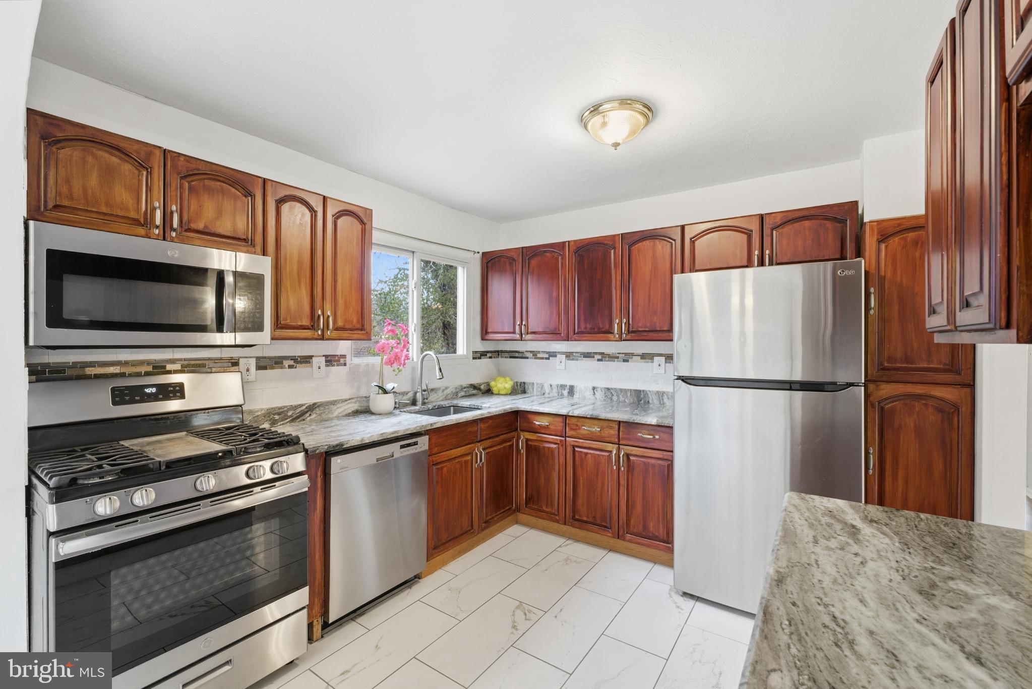 80 Mitchell Avenue Piscataway, NJ 08854 - Photo 13 of 32 a kitchen with stainless steel appliances granite countertop a refrigerator stove a sink dishwasher and microwave