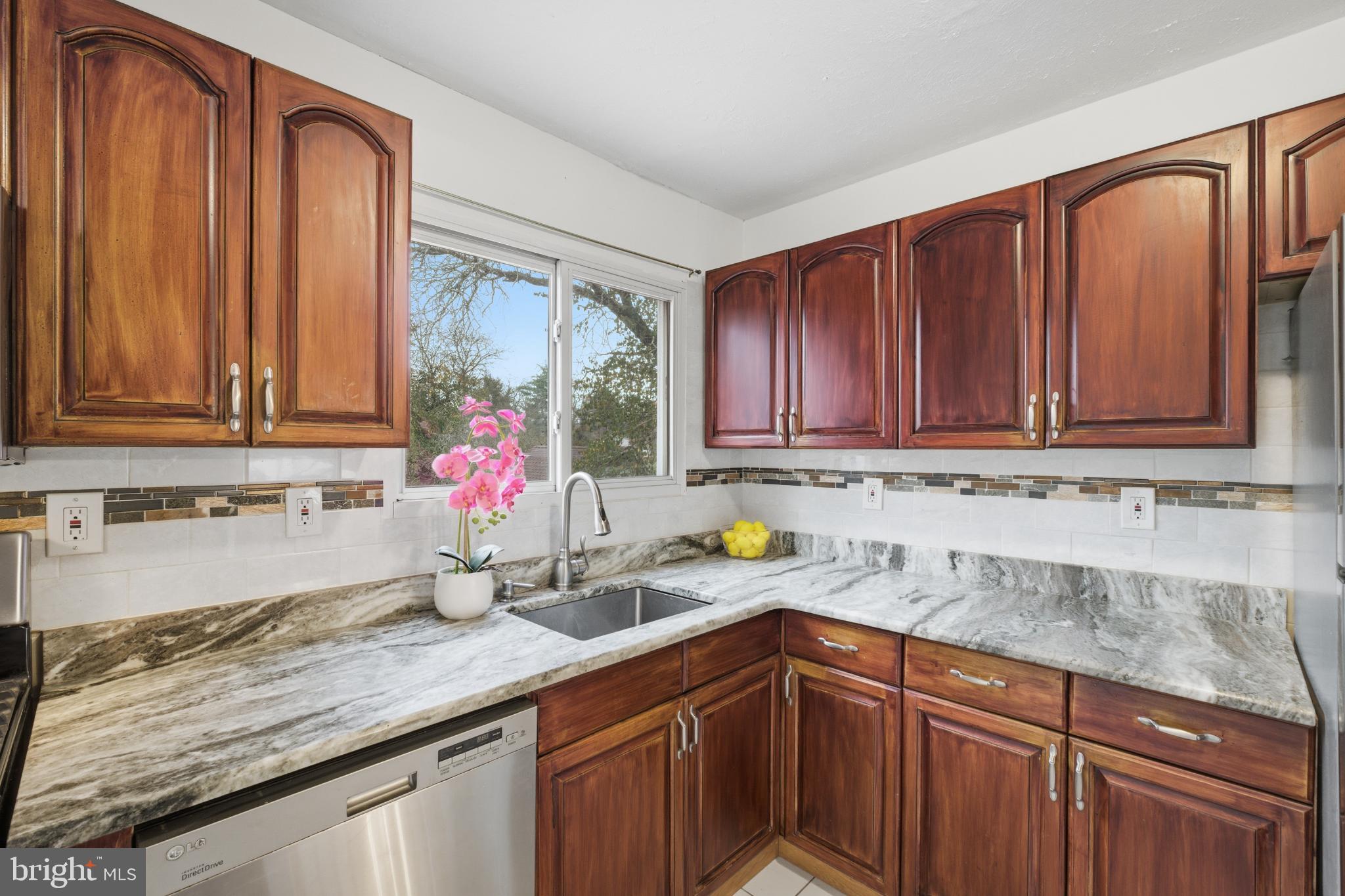 80 Mitchell Avenue Piscataway, NJ 08854 - Photo 15 of 32 a kitchen with stainless steel appliances granite countertop a sink dishwasher cabinets and granite countertops with wooden floor