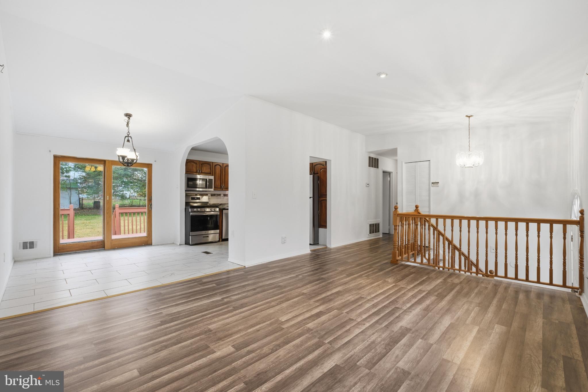 80 Mitchell Avenue Piscataway, NJ 08854 - Photo 2 of 32 a view of an empty room with a window and wooden floor