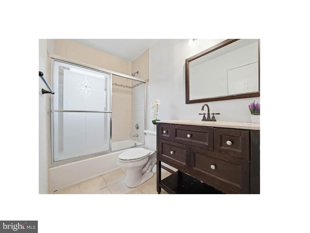 80 Mitchell Avenue Piscataway, NJ 08854 - Photo 23 of 32 a bathroom with a toilet a sink and mirror