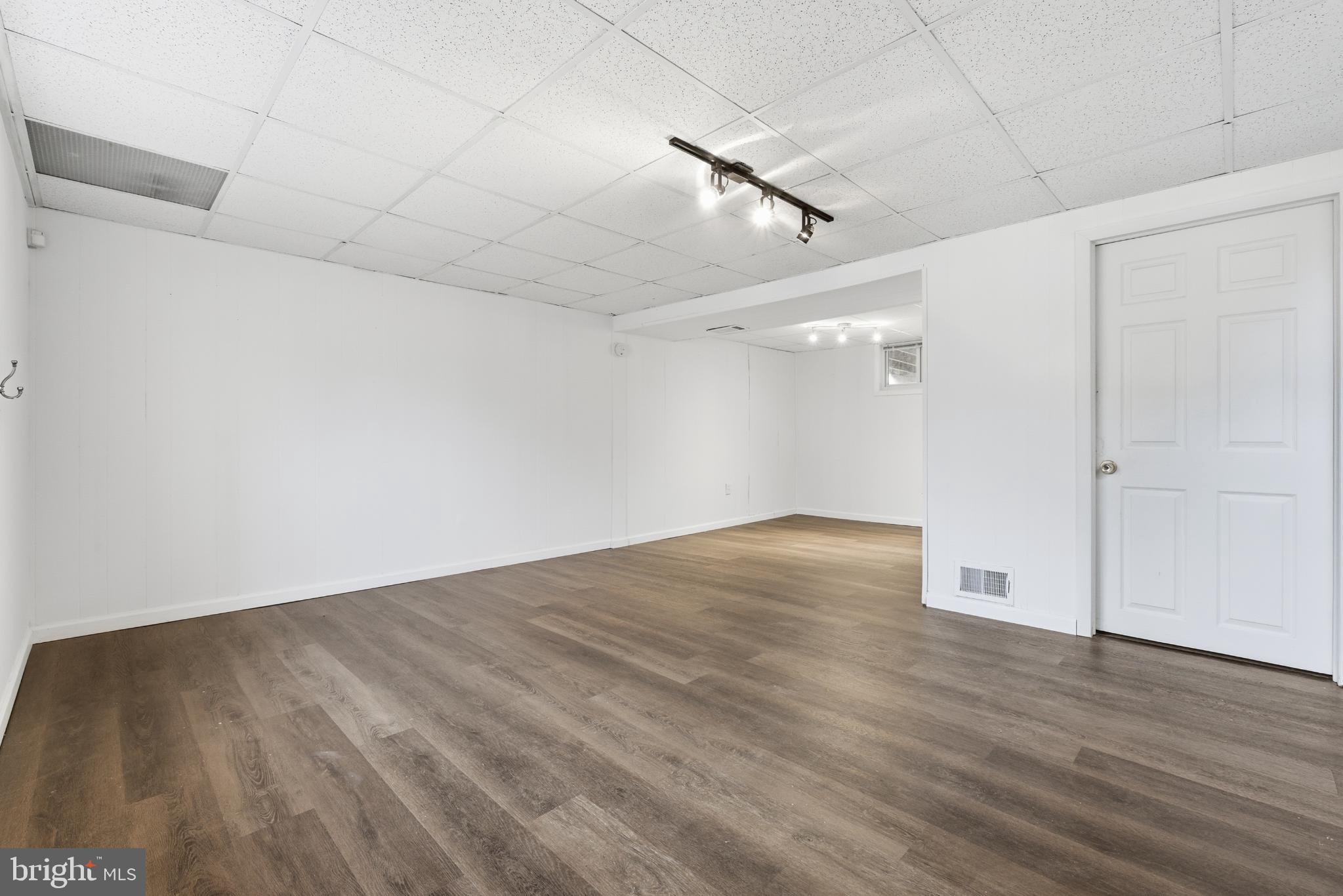 80 Mitchell Avenue Piscataway, NJ 08854 - Photo 27 of 32 an empty room with wooden floor and windows