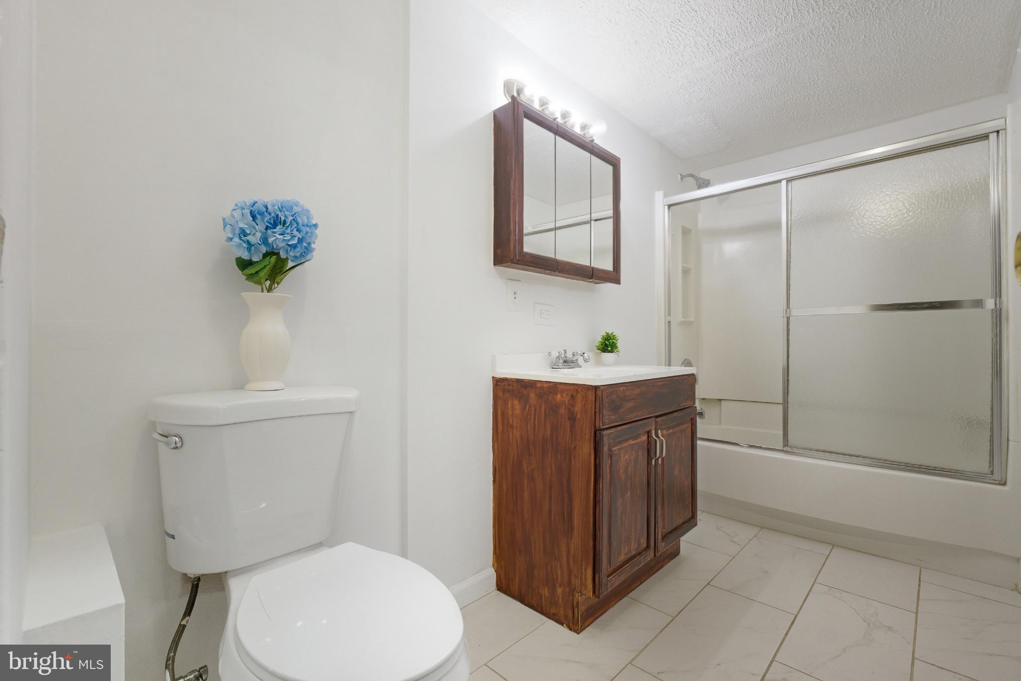 80 Mitchell Avenue Piscataway, NJ 08854 - Photo 28 of 32 a bathroom with a toilet a sink and mirror