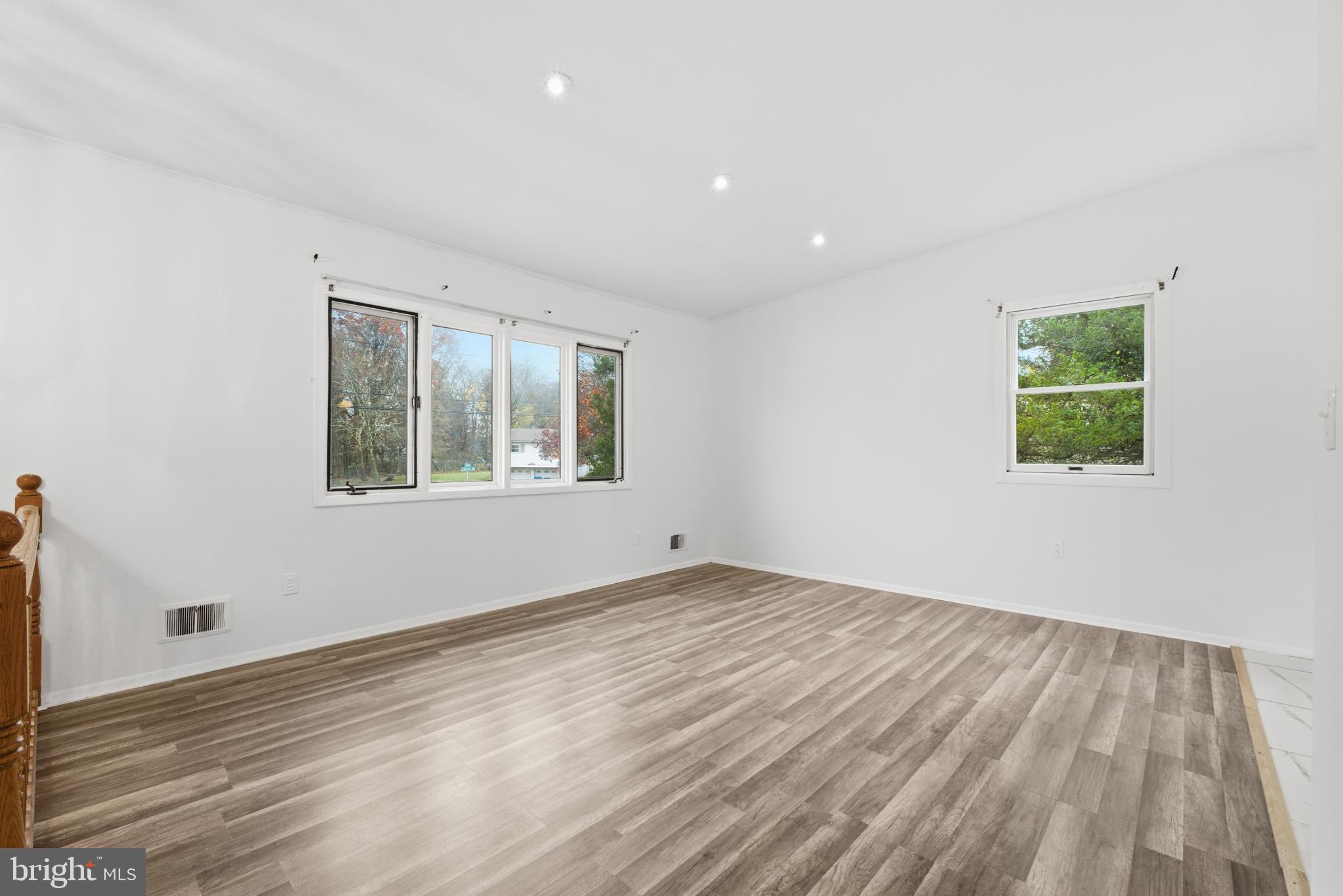 80 Mitchell Avenue Piscataway, NJ 08854 - Photo 4 of 32 a view of an empty room with wooden floor and a window