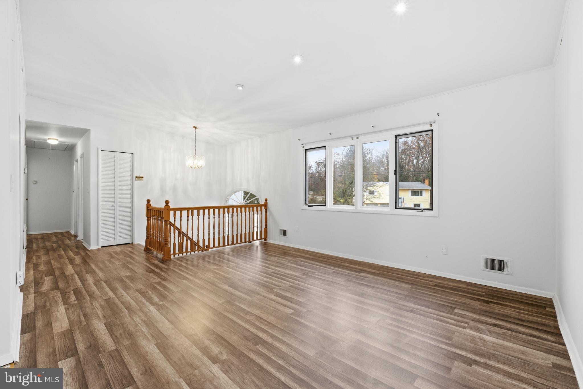 80 Mitchell Avenue Piscataway, NJ 08854 - Photo 6 of 32 a view of an empty room with wooden floor and a window