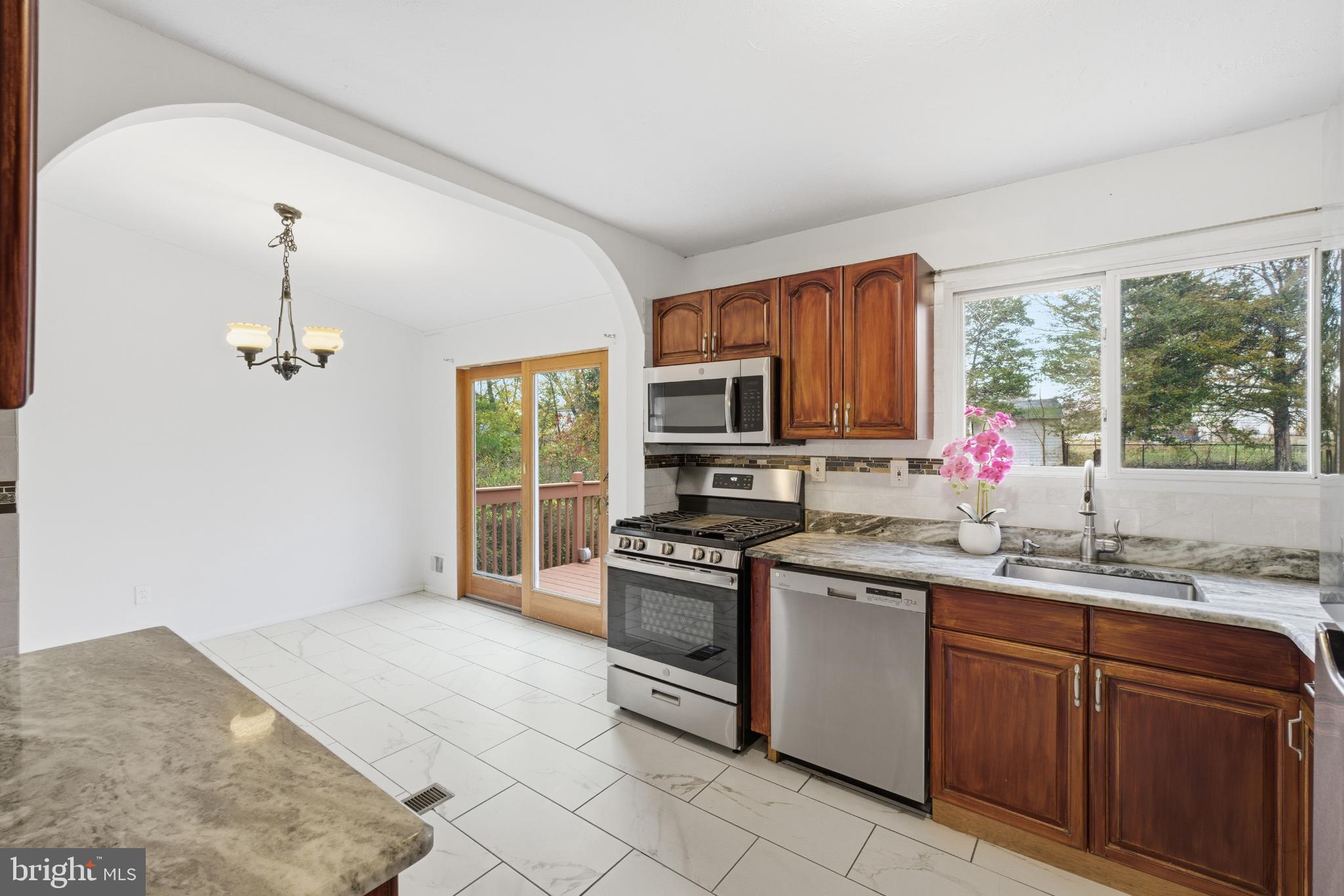 80 Mitchell Avenue Piscataway, NJ 08854 - Photo 10 of 32 a kitchen with a sink stove top oven and cabinets