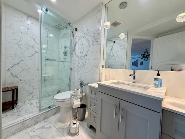 a bathroom with a sink toilet and shower