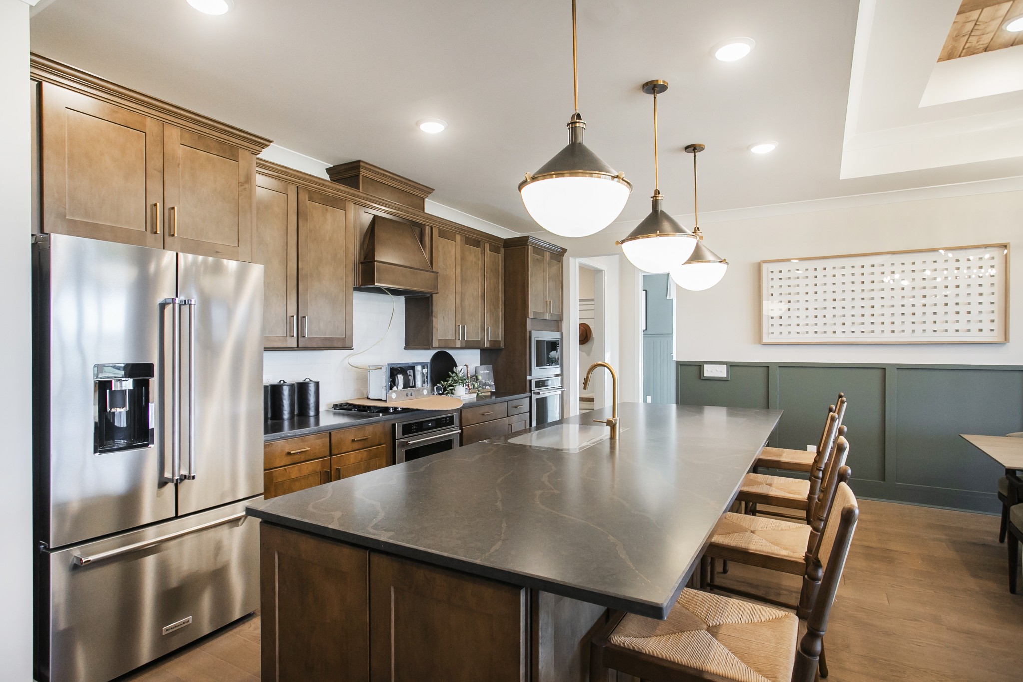 19 Pinnacles Lane Lebanon, TN 37090 - Photo 38 of 50 a kitchen with stainless steel appliances kitchen island granite countertop a refrigerator a stove a kitchen island a dining table and chairs with wooden floor