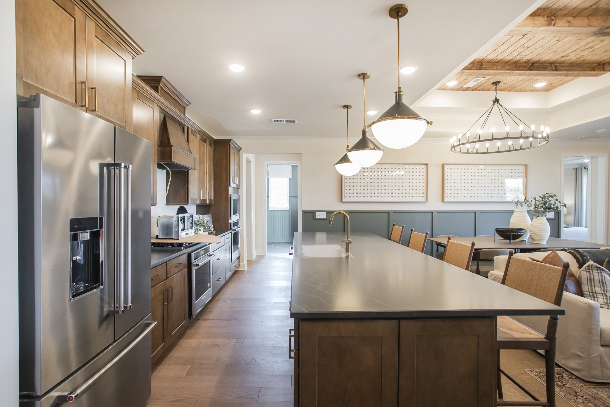 19 Pinnacles Lane Lebanon, TN 37090 - Photo 39 of 50 a large kitchen with stainless steel appliances kitchen island granite countertop a refrigerator a oven a dining table and chairs with wooden floor