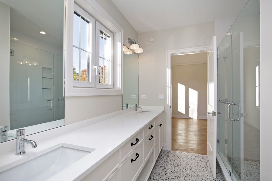 4032 Picardy Drive Northbrook, IL 60062 - Photo 20 of 38 a bathroom with a double vanity sink and a mirror