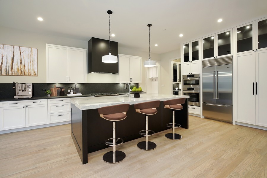 4032 Picardy Drive Northbrook, IL 60062 - Photo 3 of 38 a kitchen with stainless steel appliances granite countertop a stove a sink a refrigerator and white cabinets with wooden floor