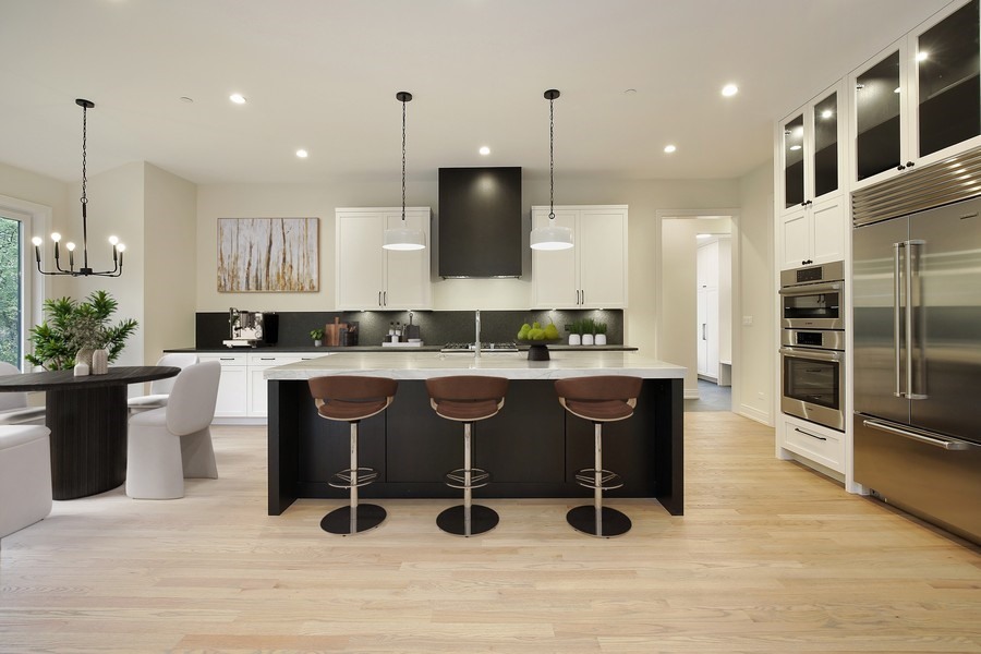 4032 Picardy Drive Northbrook, IL 60062 - Photo 4 of 38 a kitchen with kitchen island granite countertop a sink counter and chairs