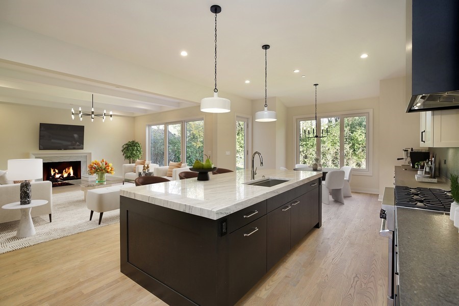 4032 Picardy Drive Northbrook, IL 60062 - Photo 6 of 38 a large kitchen with stainless steel appliances a large counter top a sink a stove and a wooden floor