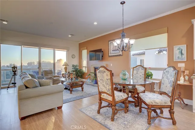 a kitchen with stainless steel appliances granite countertop dining table chairs and white cabinets
