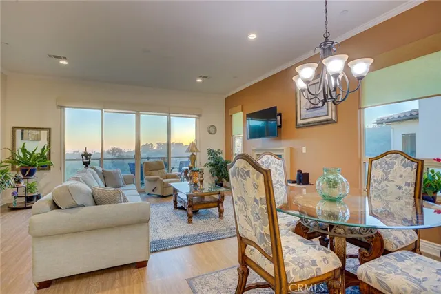 a living room with fireplace furniture and a large window